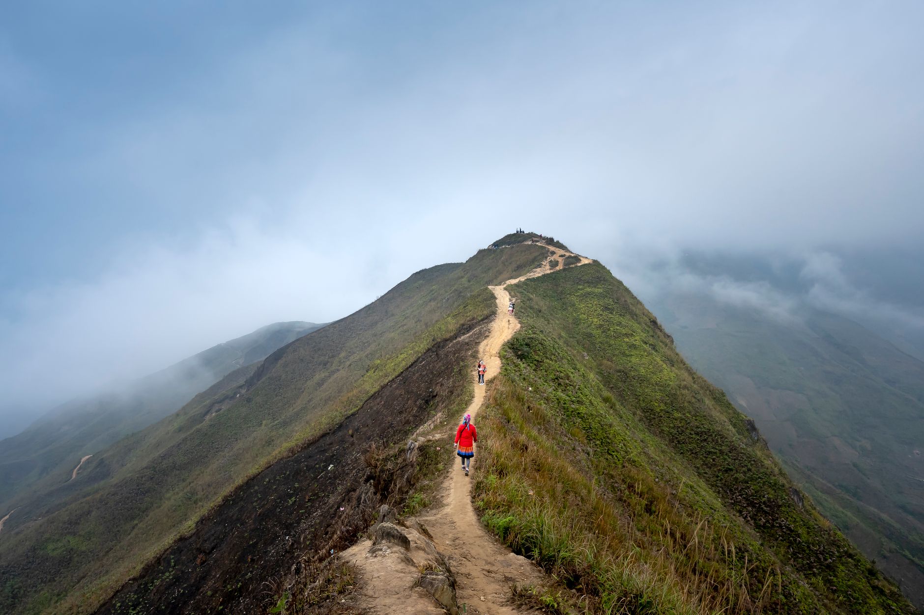 Hikers on mountain pass overlooking valley